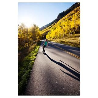 young woman longboards down a smooth country roa Poster