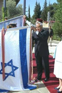 President Moshe Katsav attaching the ribbon onto the national flag