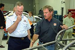 Terry Labonte, on the right, shows the frame of a race car in 2005