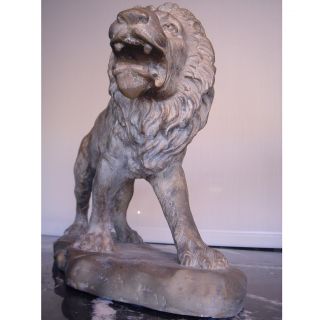 pair of cast metal sculptures of a lion and lioness cast in a bronze