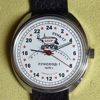 white dial with black and red letters, black hands , central second
